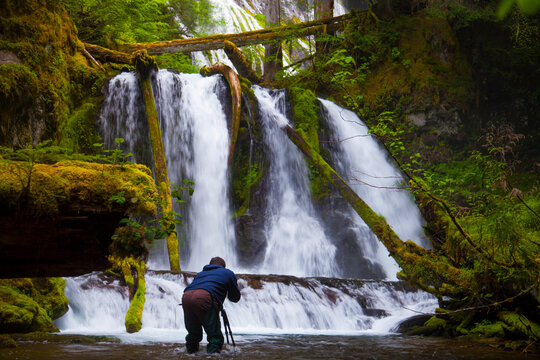 A photographer takes a picture of Lower Panther Falls.