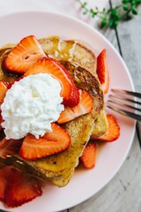 French toast topped with strawberries whipped cream