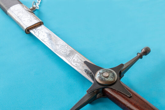 Cossack sword in a scabbard, close-up on a blue background
