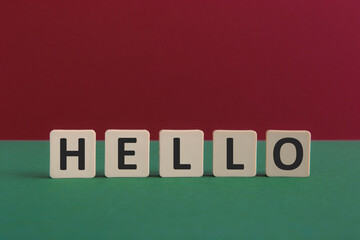 Words HELLO written with leisure game tiles. Conceptual image representing a testual message communicated using letters from a board game.