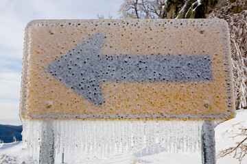 Road sign covered in ice on Route 17 in Fayston, Vermont.