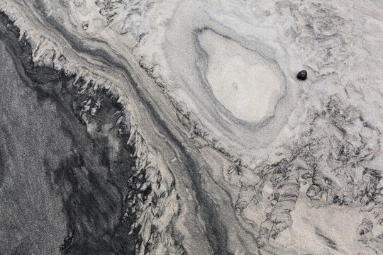 Patterns caused by sediment transport by water in the sand on Horseid Beach, Moskenesoya, Lofoten Islands, Norway.