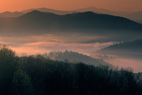 Foggy valleys and layered mountain forms define the distant view of Great Smoky Mountains National Park in the early morning from Foothills Parkway, Tennessee