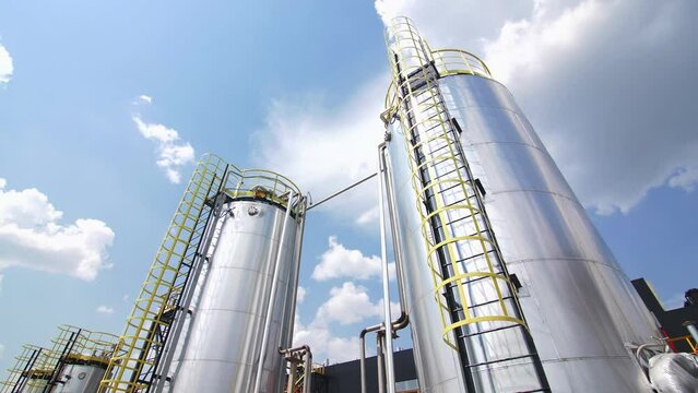 High steel cisterns with service grounds at carbon fiber manufacturing plant. Chemical products processing equipment