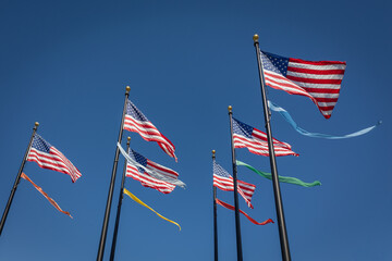 The american flag with the stars and stripes waving in the clear blue sky, San Francisco, California, USA