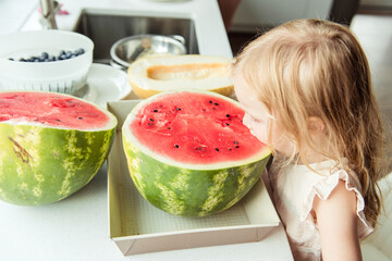 Little girl eating a watermelon