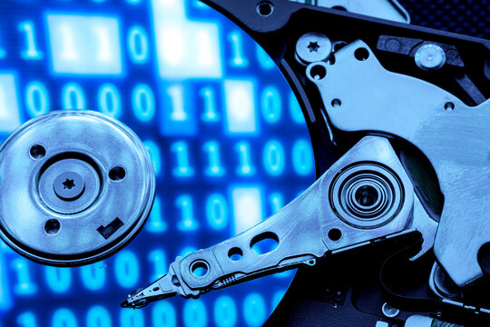 Closeup of an hard disk under a blue light with reflection of code