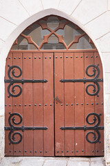 Estonia, Tallinn - July 21, 2022: Closeup of Brown stylish gate door to backyard, transom framed...