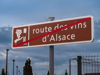 A sign and a symbol for the End of the Route des vins in Alsace, France. English translation: Wine...