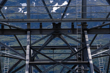 large metal structures with ropes and ladders high in the mountains