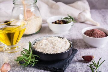 Tahini sauce from sesame seeds in a bowl and ingredients for cooking on the table