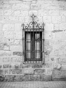 Latticed window in an old house in a village in rural Spain.