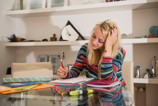 Young student doing homework in the living room, Bavaria, Germany