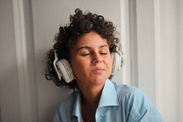 young woman listens to music with headphones