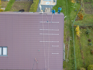 Installation of photovoltaic panels. Aerial view of the construction of the photovoltaic power plant of the family house.