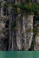 fragrant green water, crossed on the horizon by a straight vertical cliff overgrown with some green bushes