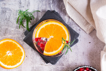 Hard seltzer alcoholic cocktail with orange, berries and rosemary in glasses. Top view. Closeup
