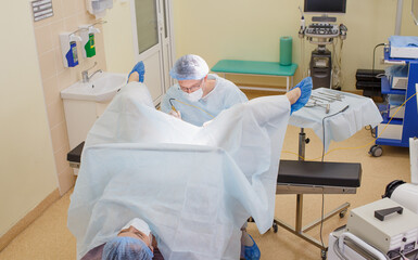 Patient and doctor in hospital during colonoscopy, close-up. Examination of the patient in the...