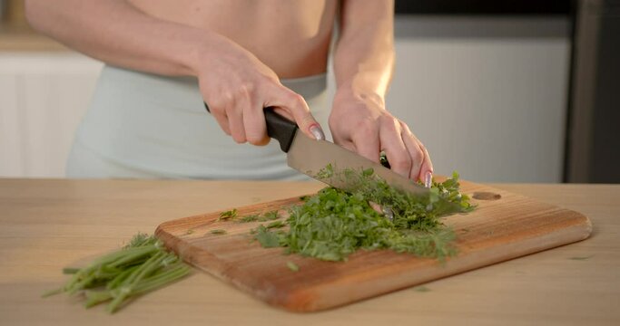 Fit woman making healthy vegetable salad for breakfast