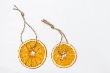 Two slices of dried orange on a string, decoration for the Christmas tree.