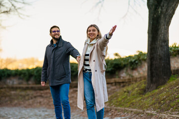 A portrait of a happy romantic couple walking outdoors in the surroundings of an old fortress