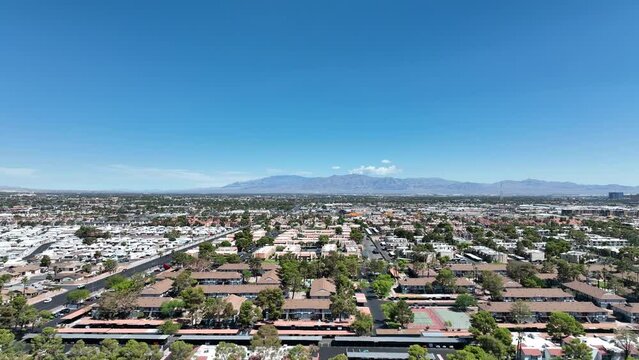 Aerial view across urban suburban communities in Las Vegas Nevada with streets, rooftops, and homes 