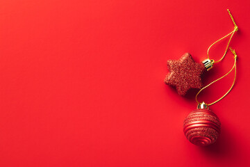 Red christmas decoration. Christmas bulbs on red background. Top view.