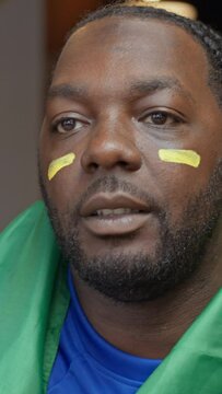 Woman applying face paint on soccer fans face