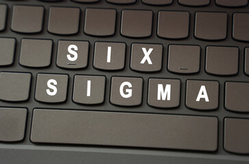 On the black keyboard, the inscription is highlighted in white - Six Sigma