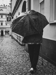 woman with umbrella on rainy day in town
