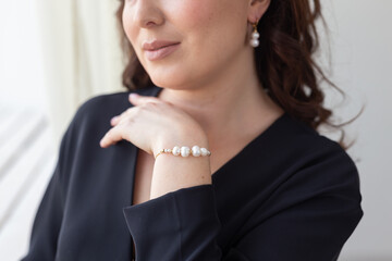 Close-up of woman wearing pearl bracelet. Jewelry, bijouterie and accessories concept
