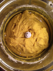 Homemade saffron dough in a food processor for baking buns for December holidays.