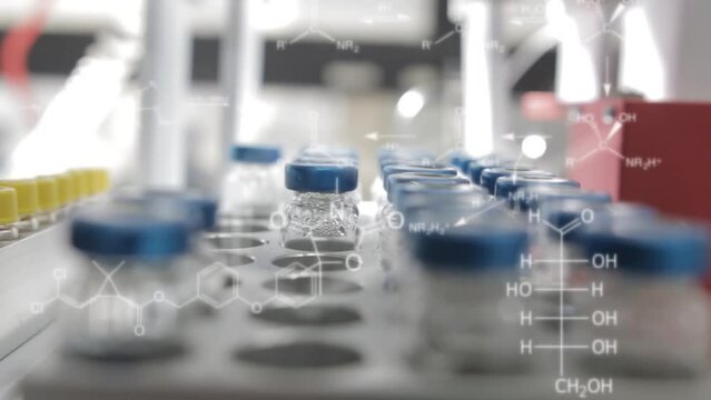 Analytical chemistry autosampler is loaded with vials while chemical structures of drugs and vitamins apper in a overlay