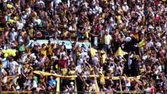 Blurred People in Crowded Soccer Stadium in South America. 4K Resolution.