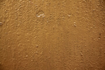 The old metal wall is golden in color. Background texture.