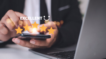 customer hand  with gold five star rating feedback icon and press level excellent rank for giving best score point to review the service, business concept