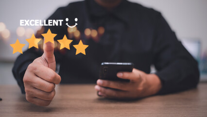 customer hand  with gold five star rating feedback icon and press level excellent rank for giving best score point to review the service, business concept