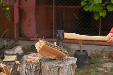 the axe cleaver splits a wooden log in half.