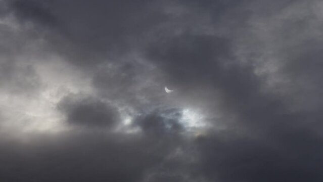 A solar eclipse in cloudy weather through a cloud. partial solar eclipse.