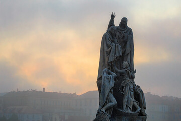 Cityscape - view of statue of Saints Cyril and Methodius on Charles Bridge in the early morning,...