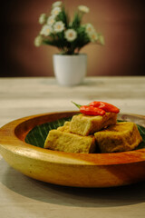 Fried tofu with red chili on top.