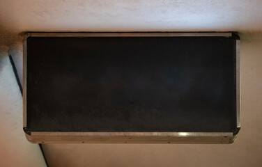 Blank black and white concrete wall. Blank black sign plate on textured wall. Mockup of a plate metal sign	
