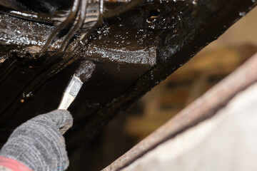 Fototapeta metal treatment with anti-corrosion lubricant underbody protection car obraz