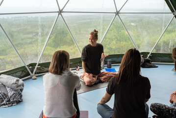 Yoga teacher explaining the technique and phylosophy of practice