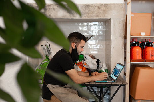 Shop local business owner at work with laptop