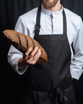 Chef holding bread loaf