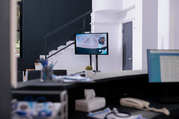 Empty front desk with nobody in it full with medical papers prepared for patient examination, medicine service. Hospital waiting room reception counter with office supplies and promotional flyers.