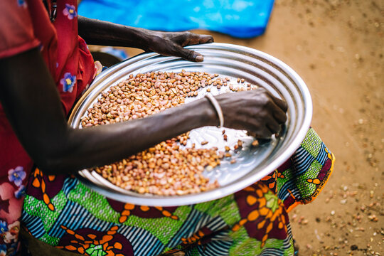 Crop black woman with coffee beans in outdoor market
