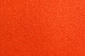 Orange texture velour or suede cloth close-up. Natural or artificial sewing material. Fabric as...