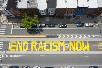 Aerial view of Philadelphia cityscape with a ground Mural "End Racism Now" on a sunny day